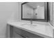 Modern bathroom features quartz counters, a gray vanity, and large mirror at 6332 W Sunnyslope Ln, Glendale, AZ 85302