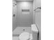 Modern bathroom features tiled walls and floors and a new toilet and shower at 6332 W Sunnyslope Ln, Glendale, AZ 85302