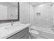 Bathroom features white quartz counters, modern faucet, tiled shower, and neutral walls at 6332 W Sunnyslope Ln, Glendale, AZ 85302