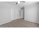 Bright bedroom features neutral walls, carpet, ceiling fan and sliding closet doors at 6332 W Sunnyslope Ln, Glendale, AZ 85302