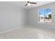 Bedroom featuring a ceiling fan and large window with a neighborhood view at 6332 W Sunnyslope Ln, Glendale, AZ 85302