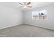 This bedroom features neutral walls and carpet and has a window that lets in sunlight at 6332 W Sunnyslope Ln, Glendale, AZ 85302