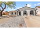 Charming single-story home with painted brick, arched windows, and a well-manicured paver driveway at 6332 W Sunnyslope Ln, Glendale, AZ 85302