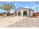 Single-story home featuring painted brick, arched windows, a spacious driveway, and desert landscaping at 6332 W Sunnyslope Ln, Glendale, AZ 85302