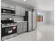 Modern kitchen with stainless steel appliances, gray cabinets, and a bright, airy feel at 6332 W Sunnyslope Ln, Glendale, AZ 85302