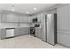 Bright kitchen with stainless steel appliances, gray cabinets, and quartz countertops at 6332 W Sunnyslope Ln, Glendale, AZ 85302