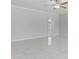 Bright living room with clean white walls, new tile floors, and a ceiling fan at 6332 W Sunnyslope Ln, Glendale, AZ 85302