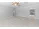 Bright living room featuring new tile floors, ceiling fan, and arched doorway to the kitchen at 6332 W Sunnyslope Ln, Glendale, AZ 85302
