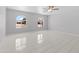 Minimalist living room featuring tile floors and arched windows providing views of the neighborhood at 6332 W Sunnyslope Ln, Glendale, AZ 85302