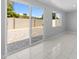 Living room featuring large sliding doors to the backyard patio with neutral color pavers at 6332 W Sunnyslope Ln, Glendale, AZ 85302