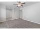 This neutral living room features carpet, a ceiling fan and closet with sliding doors at 6332 W Sunnyslope Ln, Glendale, AZ 85302