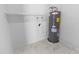 Utility closet with water heater and shelving unit at 6332 W Sunnyslope Ln, Glendale, AZ 85302