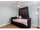 Snug bedroom with ceiling fan, small bed and side table at 6459 W Columbus Ave, Phoenix, AZ 85033