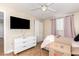 Bright bedroom featuring fan, desk, dresser and moving boxes at 6459 W Columbus Ave, Phoenix, AZ 85033