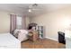 Cozy bedroom with fan, desk, shelving and moving boxes at 6459 W Columbus Ave, Phoenix, AZ 85033