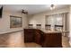 Open dining area featuring tiled floors, ceiling fan, and a granite topped breakfast bar with seating at 6459 W Columbus Ave, Phoenix, AZ 85033