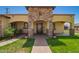 Inviting front porch with decorative stone accents, manicured lawn, and walkway at 6459 W Columbus Ave, Phoenix, AZ 85033
