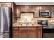 Modern kitchen featuring granite countertops, tile backsplash, and stainless steel appliances at 6459 W Columbus Ave, Phoenix, AZ 85033