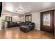 Inviting living room with tiled floors, modern sofa, and a beautiful decorative front door at 6459 W Columbus Ave, Phoenix, AZ 85033