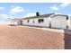 Expansive backyard featuring a covered patio, rock landscaping, and a storage shed at 6908 W Sierra St, Peoria, AZ 85345
