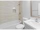 Modern bathroom features tile walls, a tub and shower, and stylish fixtures at 6908 W Sierra St, Peoria, AZ 85345