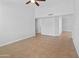 Neutral bedroom with tile floors, a ceiling fan, and an adjacent room at 6908 W Sierra St, Peoria, AZ 85345