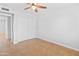 Empty bedroom offers tile floors, a ceiling fan, and white sliding closet doors at 6908 W Sierra St, Peoria, AZ 85345