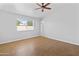 Bedroom features neutral paint, ceiling fan, and window with natural light at 6908 W Sierra St, Peoria, AZ 85345