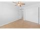 Bare bedroom shows tile floors, a ceiling fan, and closet with sliding doors at 6908 W Sierra St, Peoria, AZ 85345