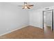 Empty bedroom with tile floors, a ceiling fan, and closet with sliding doors at 6908 W Sierra St, Peoria, AZ 85345