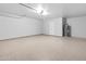 Clean two-car garage featuring epoxy flooring, utility sink, and garage door opener at 6908 W Sierra St, Peoria, AZ 85345
