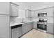 Well-lit kitchen with stainless steel appliances, gray cabinets, and white countertops at 6908 W Sierra St, Peoria, AZ 85345