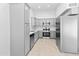 Bright kitchen featuring stainless steel appliances, light gray cabinetry, and neutral tile flooring at 6908 W Sierra St, Peoria, AZ 85345