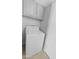 A well-lit laundry room includes a white washing machine and upper cabinets at 6908 W Sierra St, Peoria, AZ 85345