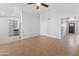Open-concept living room with modern tile floors, ceiling fan, and gray paint at 6908 W Sierra St, Peoria, AZ 85345
