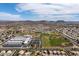 Community aerial view highlighting sports fields, school facilities, and attractive housing developments with mountain views in the distance at 6988 W Monte Lindo --, Glendale, AZ 85310