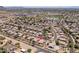 Expansive aerial view of a well-maintained community with mature trees and single-story homes, set against a backdrop of desert mountains at 6988 W Monte Lindo --, Glendale, AZ 85310