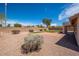 Spacious backyard with gravel, a small grassy area, and trimmed landscaping at 6988 W Monte Lindo --, Glendale, AZ 85310