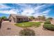 Expansive backyard featuring a green lawn, lush landscaping, a patio, and mature trees at 6988 W Monte Lindo --, Glendale, AZ 85310
