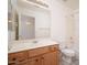 Well-lit bathroom featuring a wooden vanity, large mirror, and a combined tub and shower with white tile surround at 6988 W Monte Lindo --, Glendale, AZ 85310