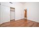 Bedroom featuring wood flooring, closet, and access to another room at 6988 W Monte Lindo --, Glendale, AZ 85310