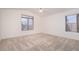 Bedroom features neutral carpet, three windows, and a ceiling fan at 6988 W Monte Lindo --, Glendale, AZ 85310