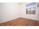 Bedroom featuring wood flooring and a window with blinds at 6988 W Monte Lindo --, Glendale, AZ 85310