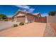Spacious driveway leading to a two-car garage, with a tile roof visible above at 6988 W Monte Lindo --, Glendale, AZ 85310