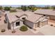 Beige single-story home featuring a tile roof, desert landscaping, and a two-car garage at 6988 W Monte Lindo --, Glendale, AZ 85310