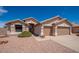Charming single-story home with a tile roof, two-car garage, and low-maintenance desert landscaping at 6988 W Monte Lindo --, Glendale, AZ 85310