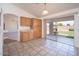 Kitchen and dining area with tile flooring, wood cabinets, and backyard access at 6988 W Monte Lindo --, Glendale, AZ 85310