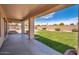 Covered patio overlooking a well-maintained lawn with mature landscaping and a block wall at 6988 W Monte Lindo --, Glendale, AZ 85310
