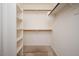 Walk-in closet featuring built-in shelving and carpet flooring at 6988 W Monte Lindo --, Glendale, AZ 85310
