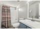 Neat bathroom with white countertops, shower-tub combo, and blue vanity at 7011 W Carol Ann Way, Peoria, AZ 85382